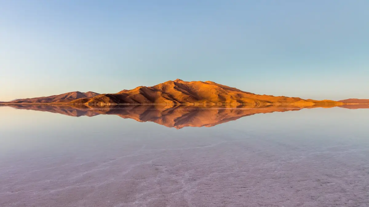 Mountains reflected in the wet salt flat