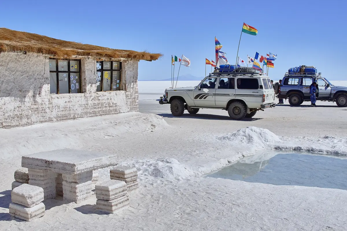 A salt building with flags and tour jeeps